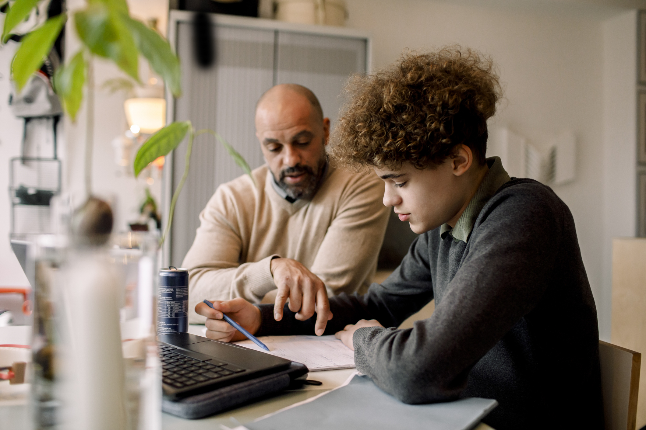 Dad and son looking at savings together.