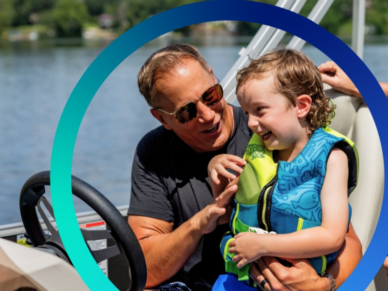 Happy Grandpa with grandson on pontoon.