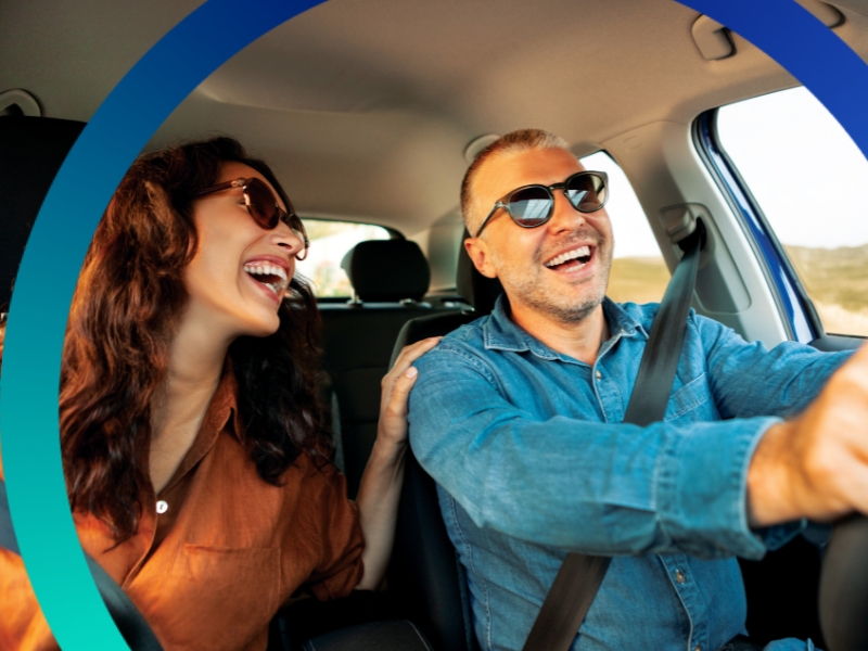 Happy couple driving in a car.