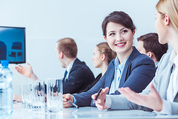 Woman smiling at board meeting