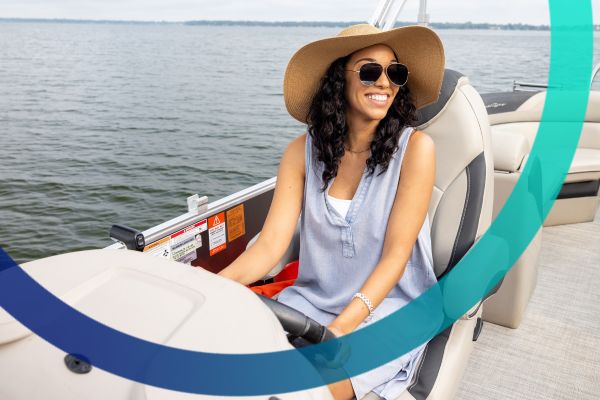 Young woman driving a pontoon boat.