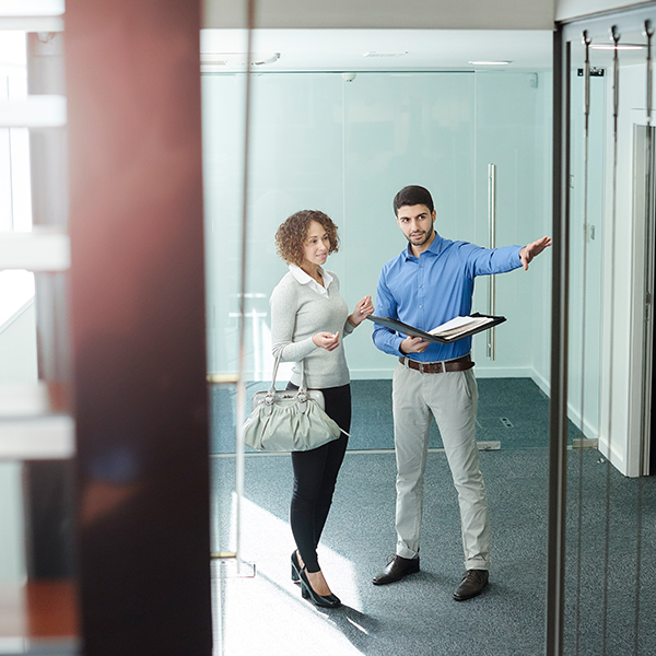 Business owner touring a new office space with realtor.