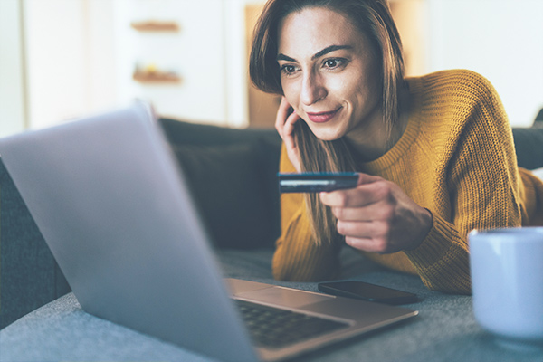 woman looking at laptop to review checking options