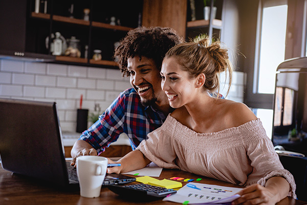 Couple reviewing their new loan on their computer