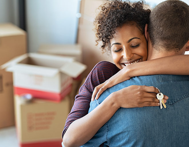 Holding the keys to their new home.