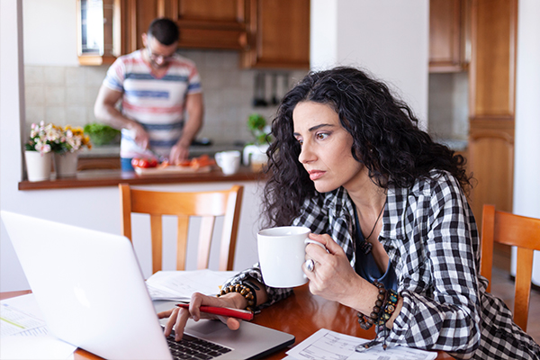 Woman reviewing finances on laptop