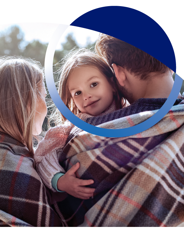 family close together wearing plaid blankets